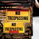 No Trespassing sticker on brown surface