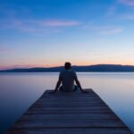 man siting on wooden dock