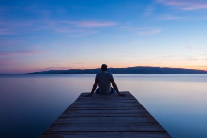 man siting on wooden dock